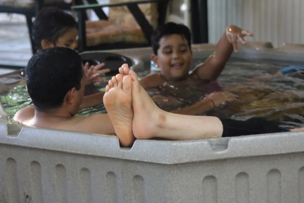 Kids taking up most of the space in a hot tub. Kids could prevent you from enjoying a peaceful soak in the hot tub.