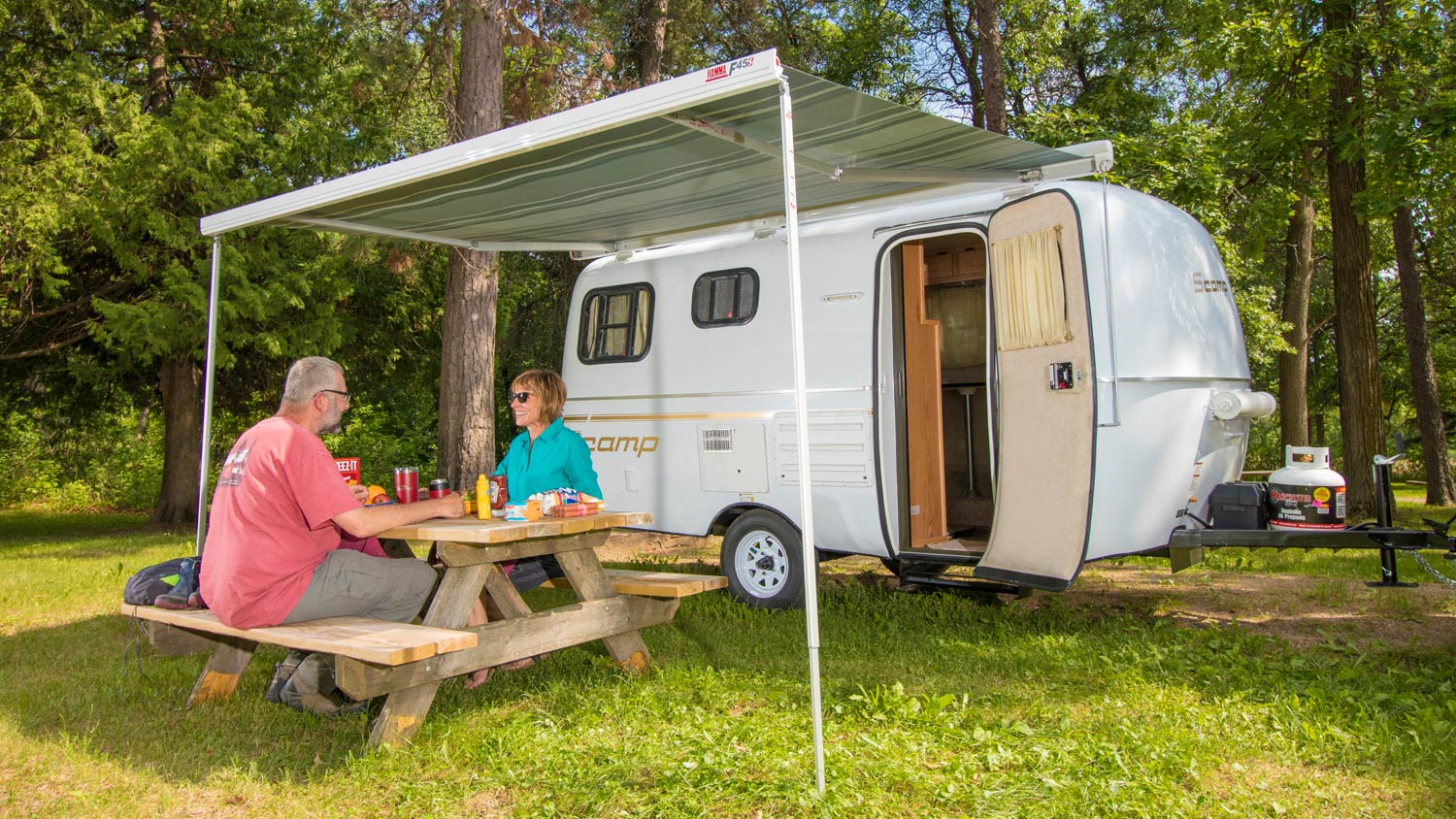 A Scamp Camper is a small, lightweight fiberglass travel trailer with a 50-...