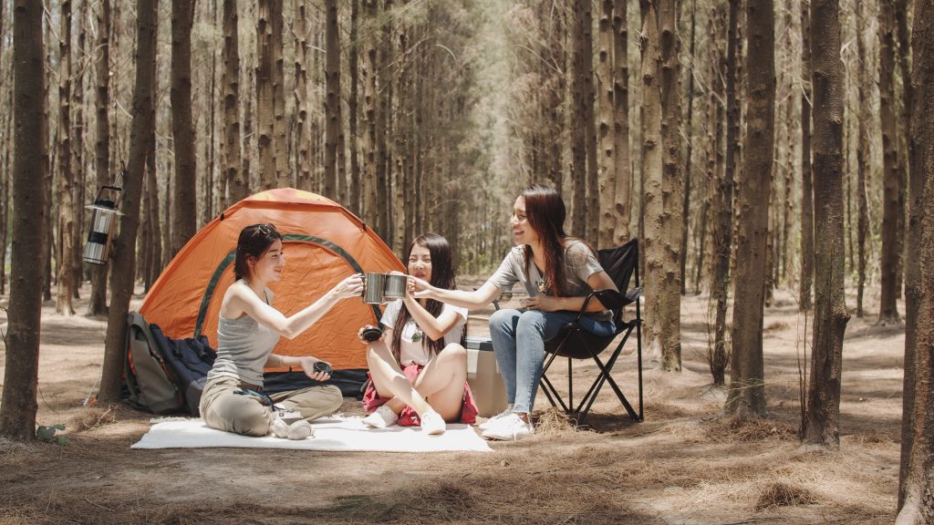 Three friends camping in trees.