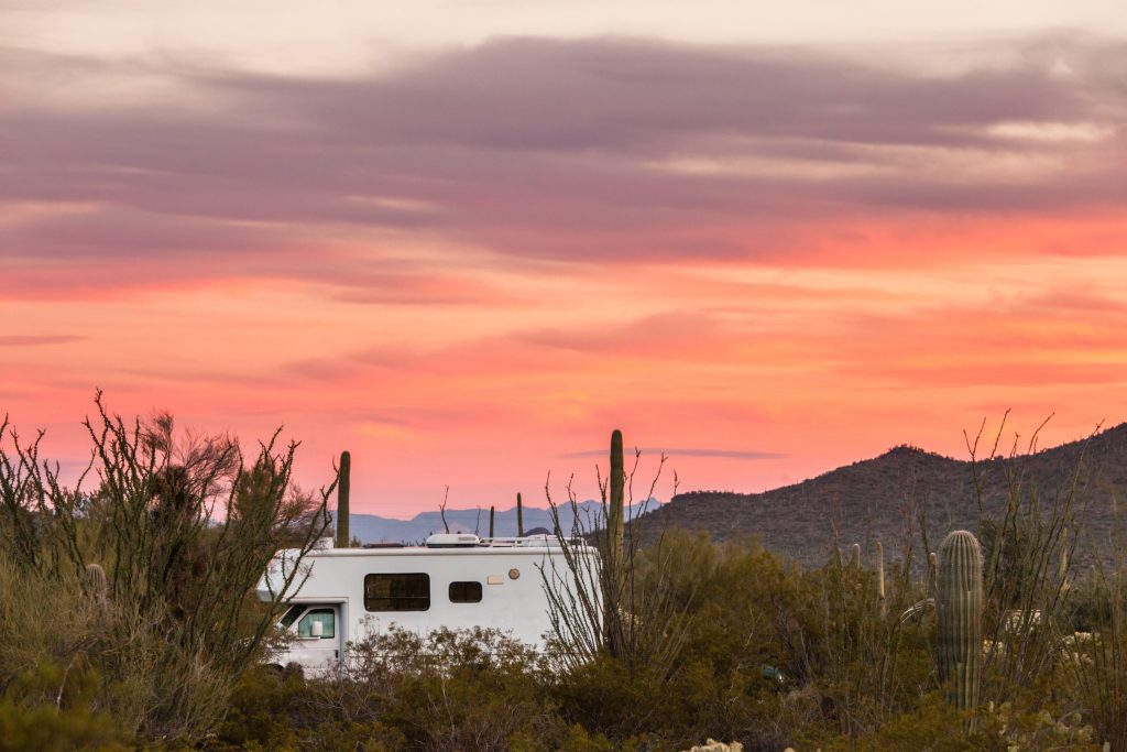 Small motorhome RV parked in the sunset