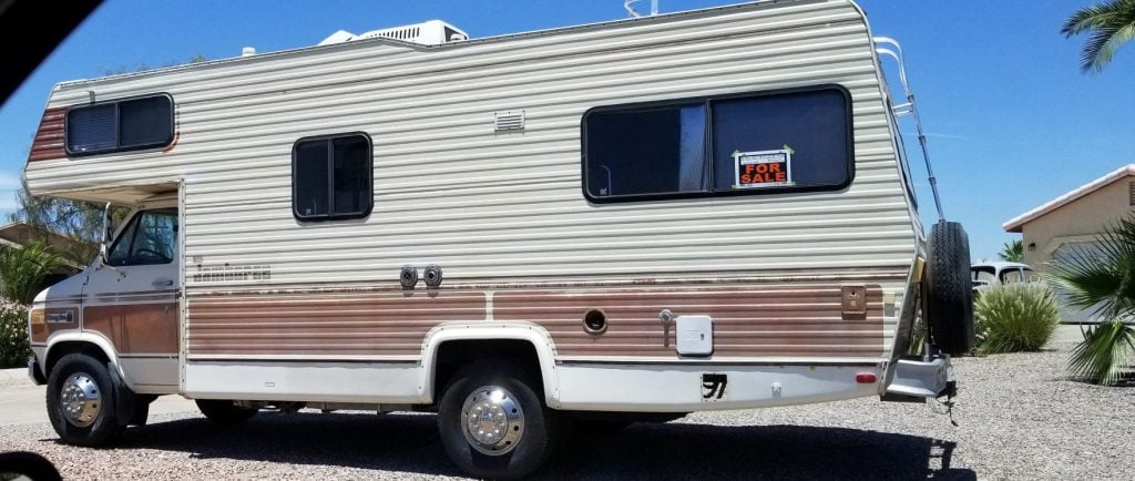 RV parked with a for sale sign.