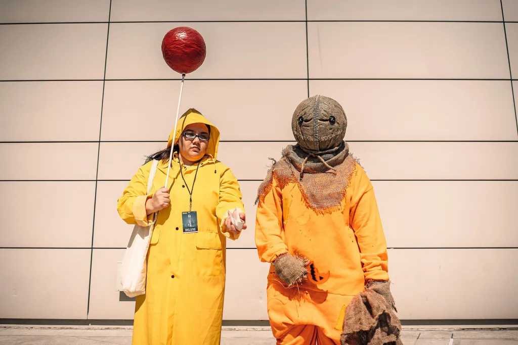 Two people cosplaying in Stephen King costumes.