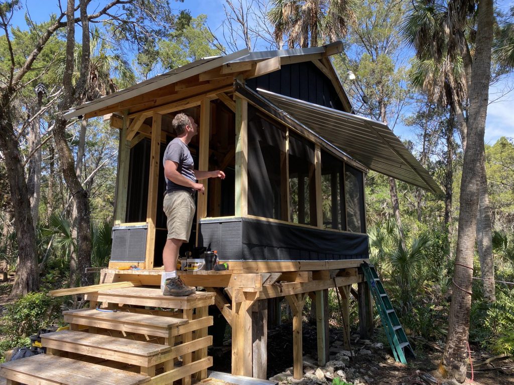 Man building tiny home.
