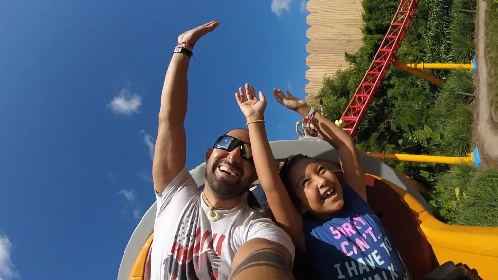 Father and daughter riding rollercoaster in Disney.