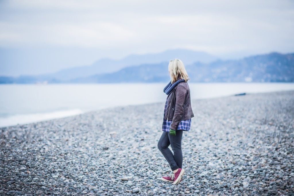 Woman looking out at ocean from Alaska.