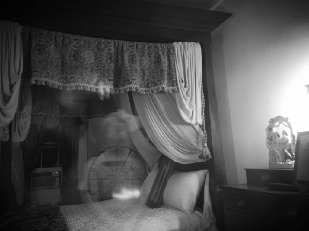 Creepy bedroom in haunted house.