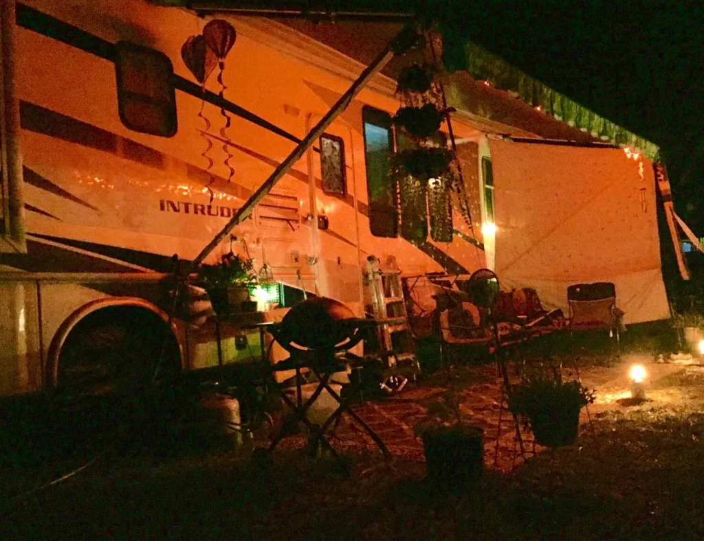 RV exterior with lights on at night.