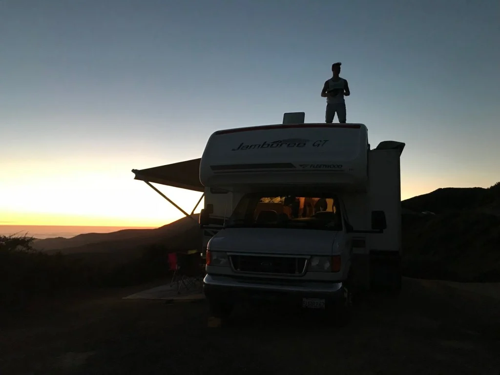 RV trailer parked at sunset.