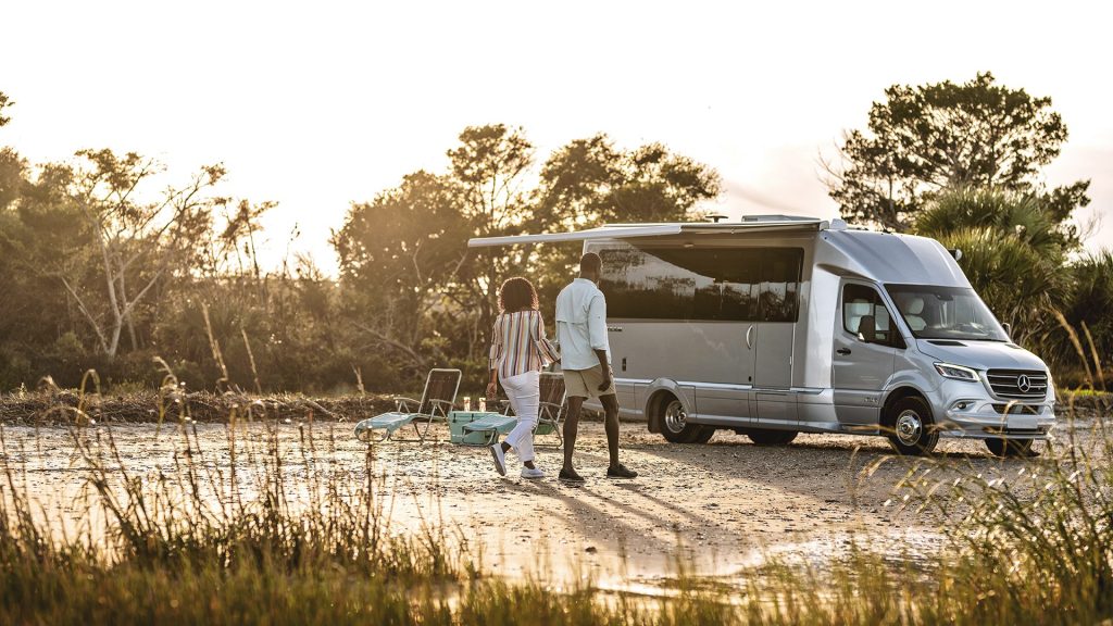 Couple walking in front of airstream atlas. Product shot from website. 