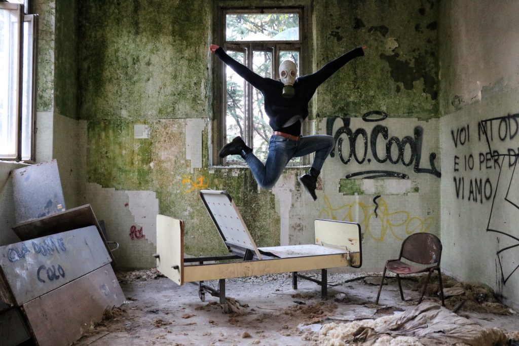 Person posing in an abandoned hospital.