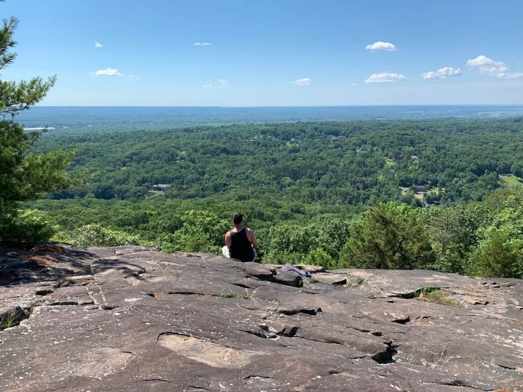 Woman taking in view in Sleeping Giant State Park.