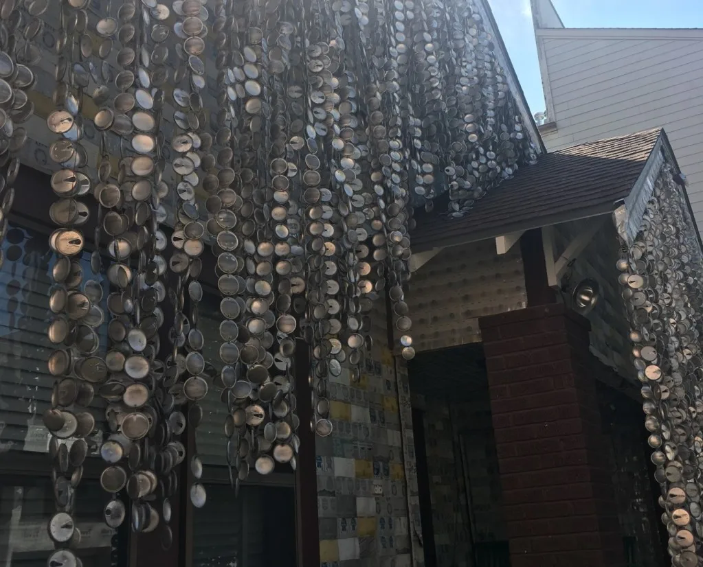 Parts of beer cans hanging on the Beer Can House.