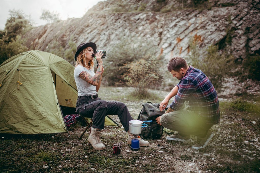 Couple drinking while camping.