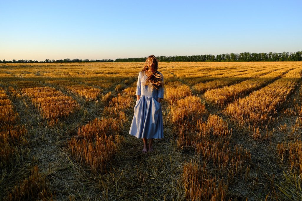 Woman standing in field.