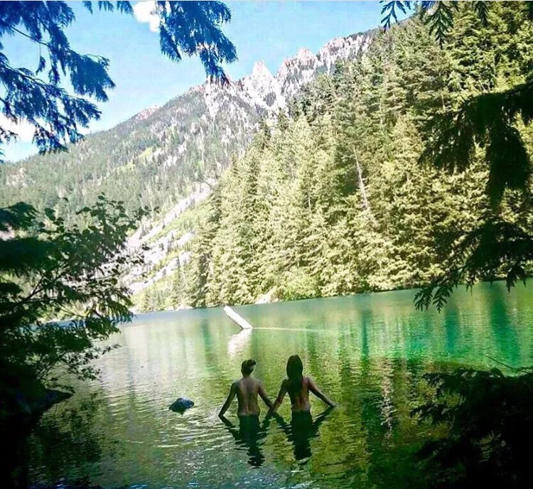 Two friends skinny dipping while camping.