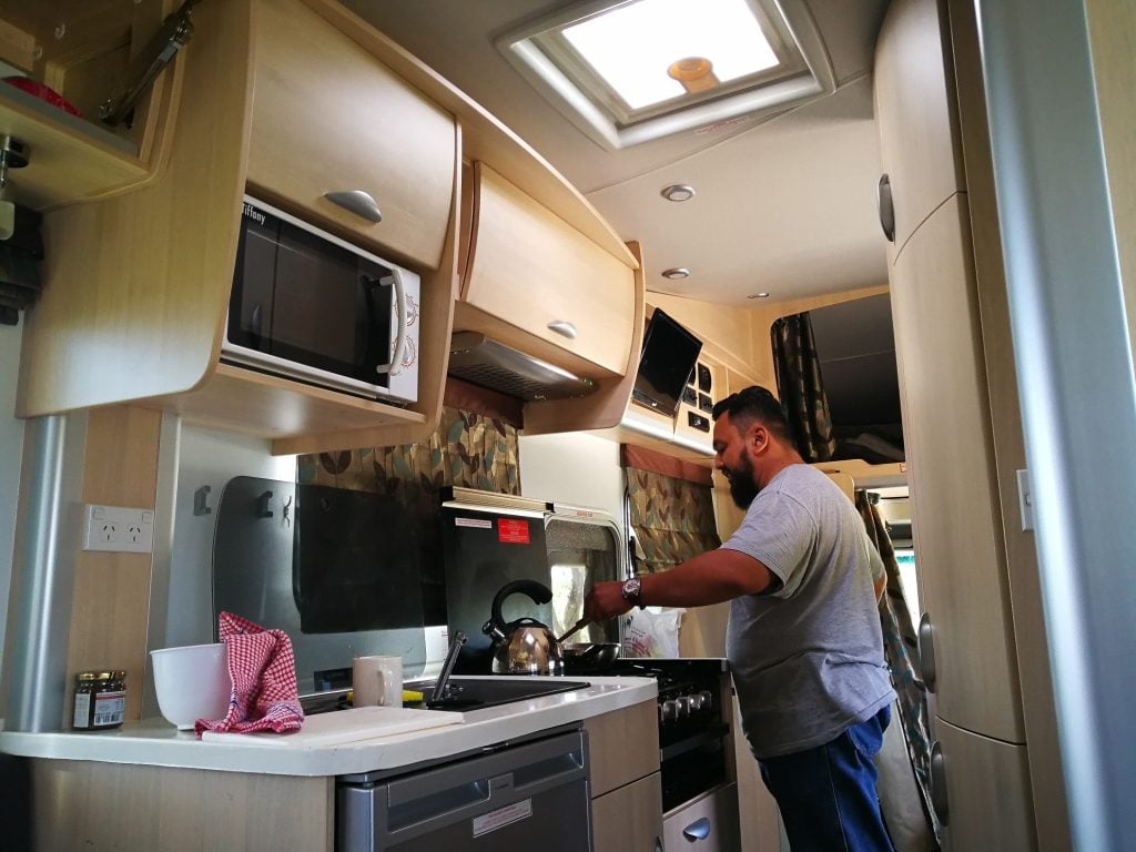 Dad cooking in RV kitchen.