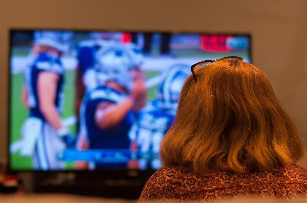 Woman watching college football.