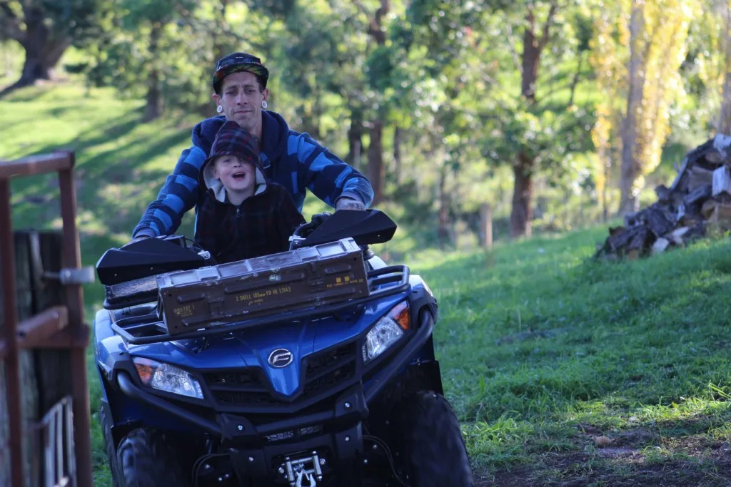 Dad and son driving ATV. 