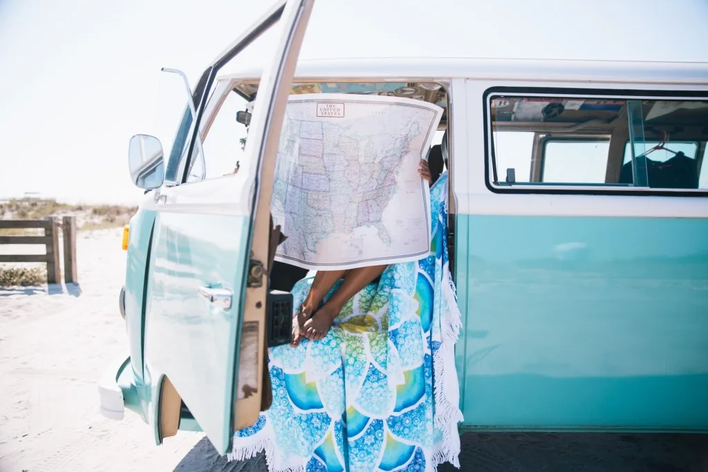 Woman reading map in camper van.