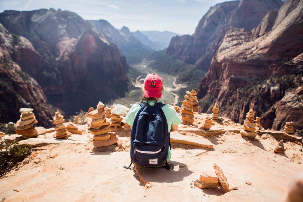 Woman sitting at summit in Zion.