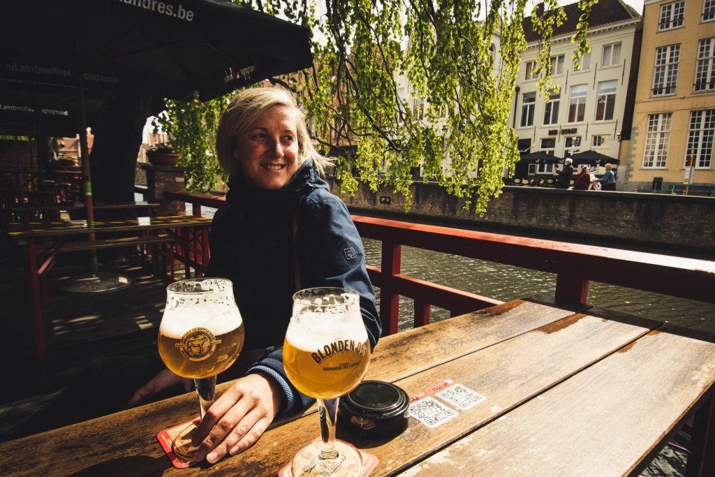 Woman drinking beer at a brewery.