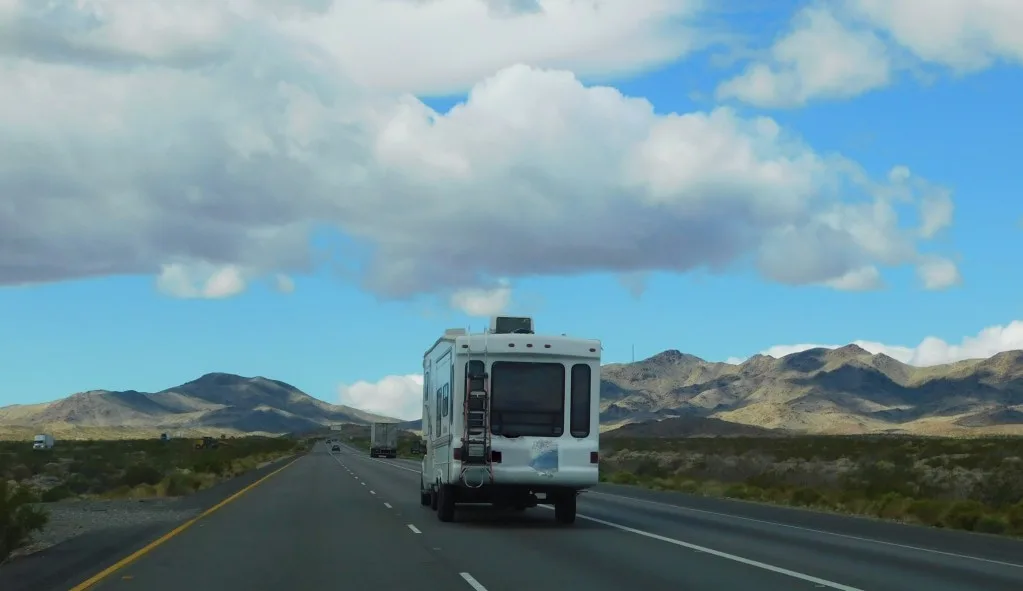 RV Fifth wheel driving down the open road.