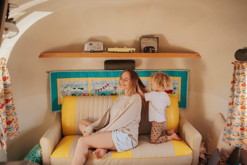 Mom and daughter playing in airstream.