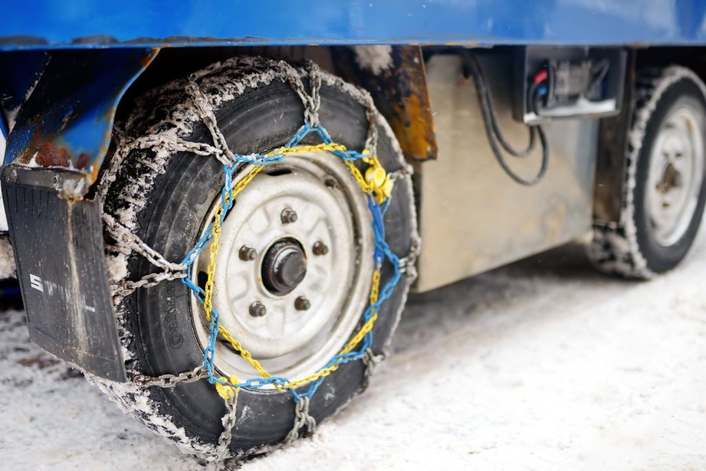Snow tires and chains on big vehicle.