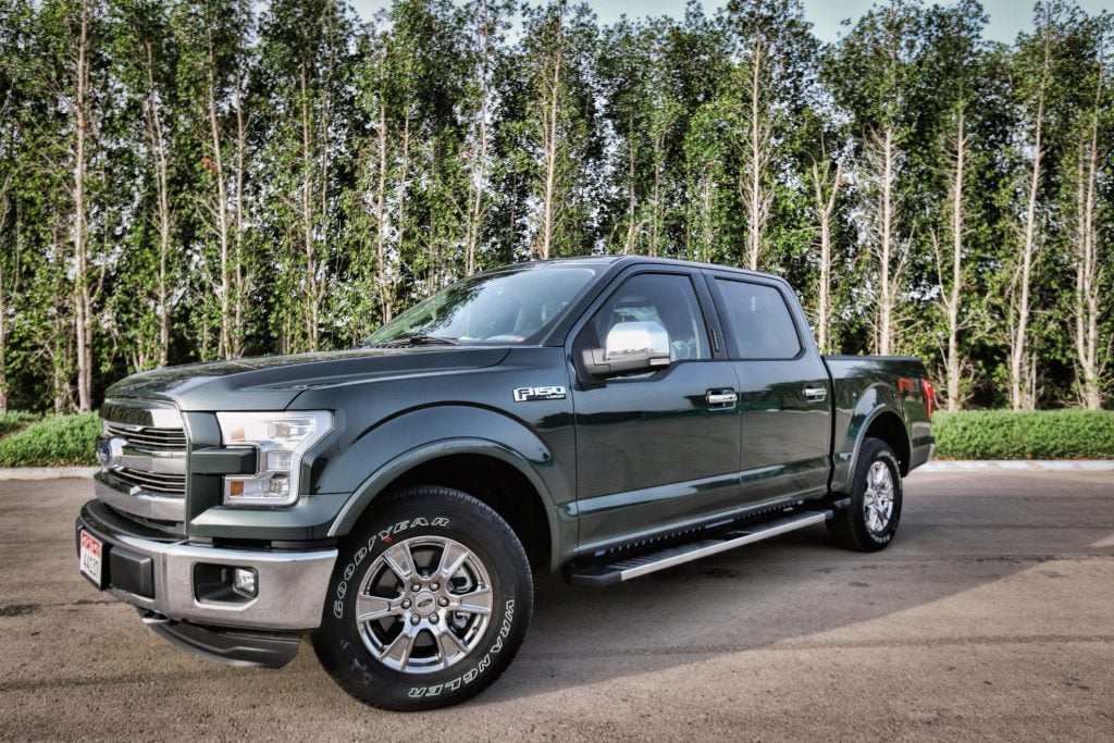 Ford F150 parked in front of trees.