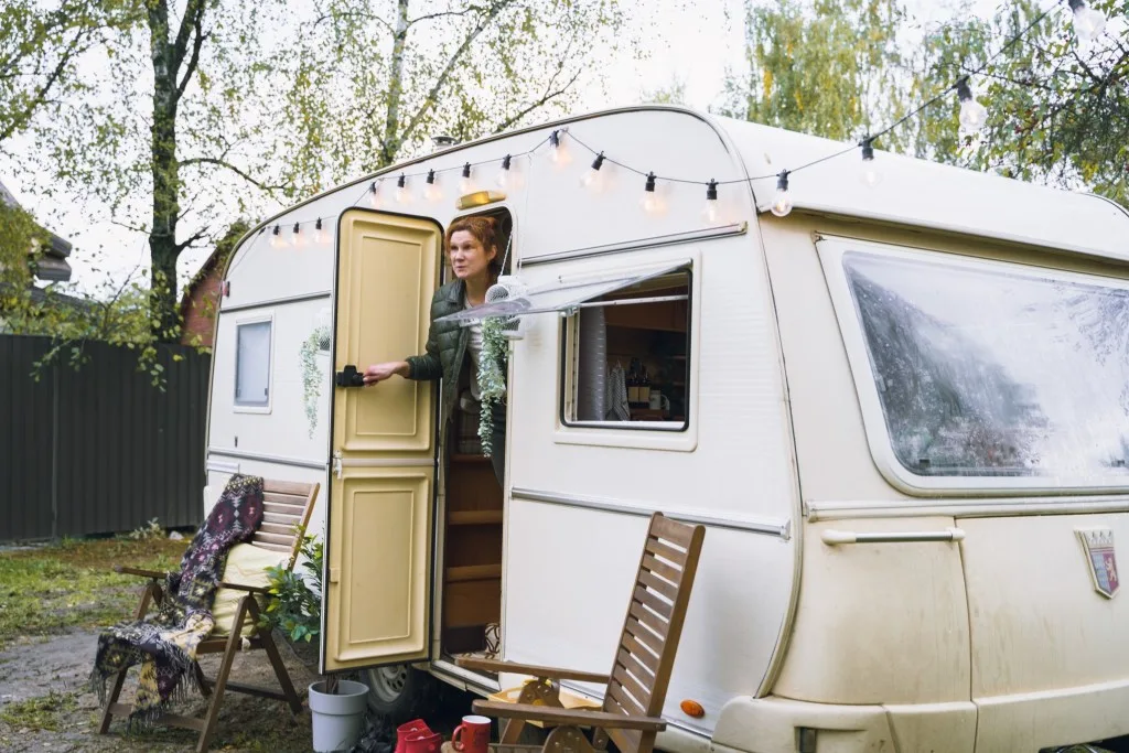 Woman leaning out RV door.