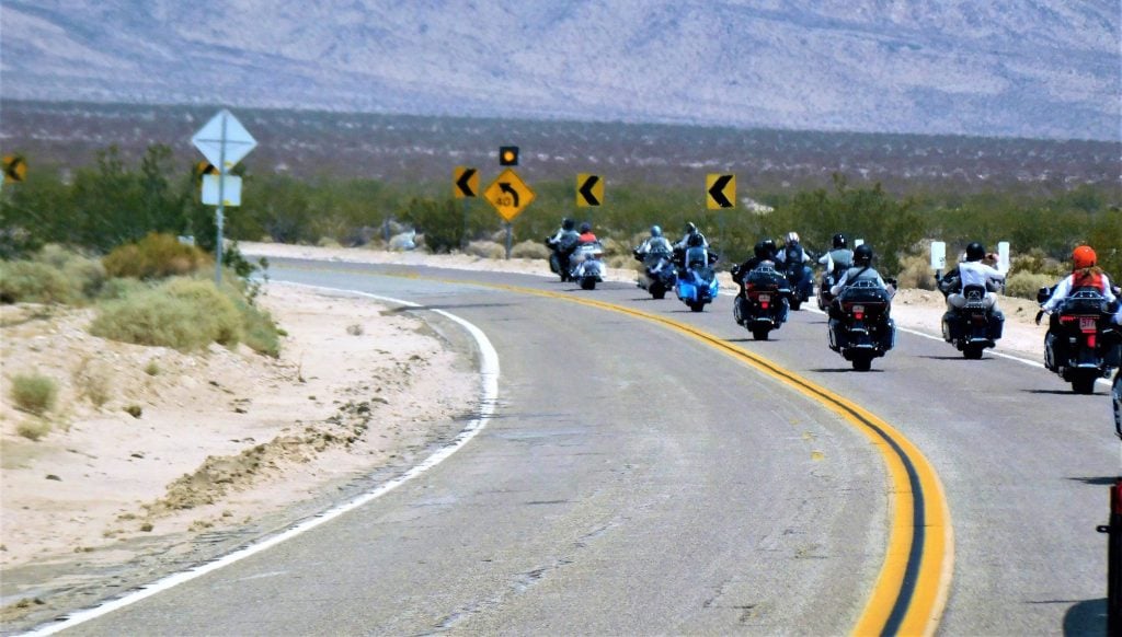 Motorcyclists driving on a winding road.