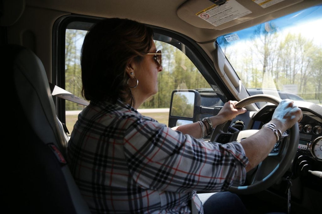 Woman driving Ford F150.