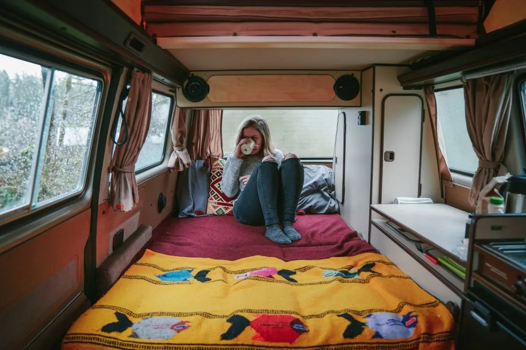 Woman drinking coffee in her RV.
