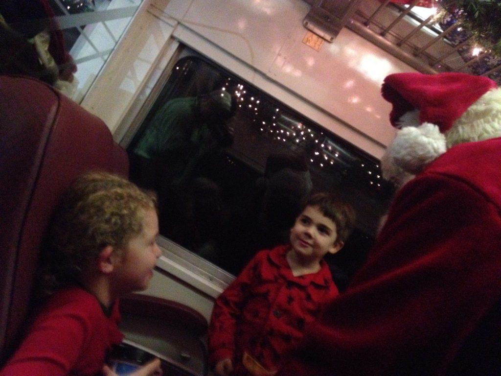 Two boys meeting Santa on the Polar Express.