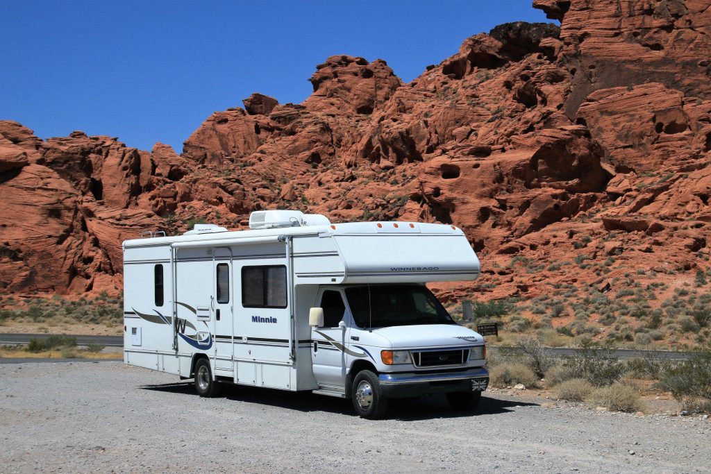 Class C RV parked by cliffs 