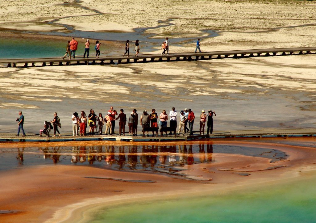 People hiking Grand Prismatic Hot Spring