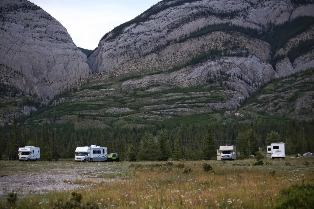 Multiple cars set up at campsite.