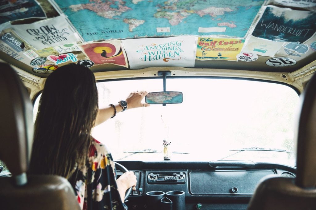 Woman on a road trip in old camper van