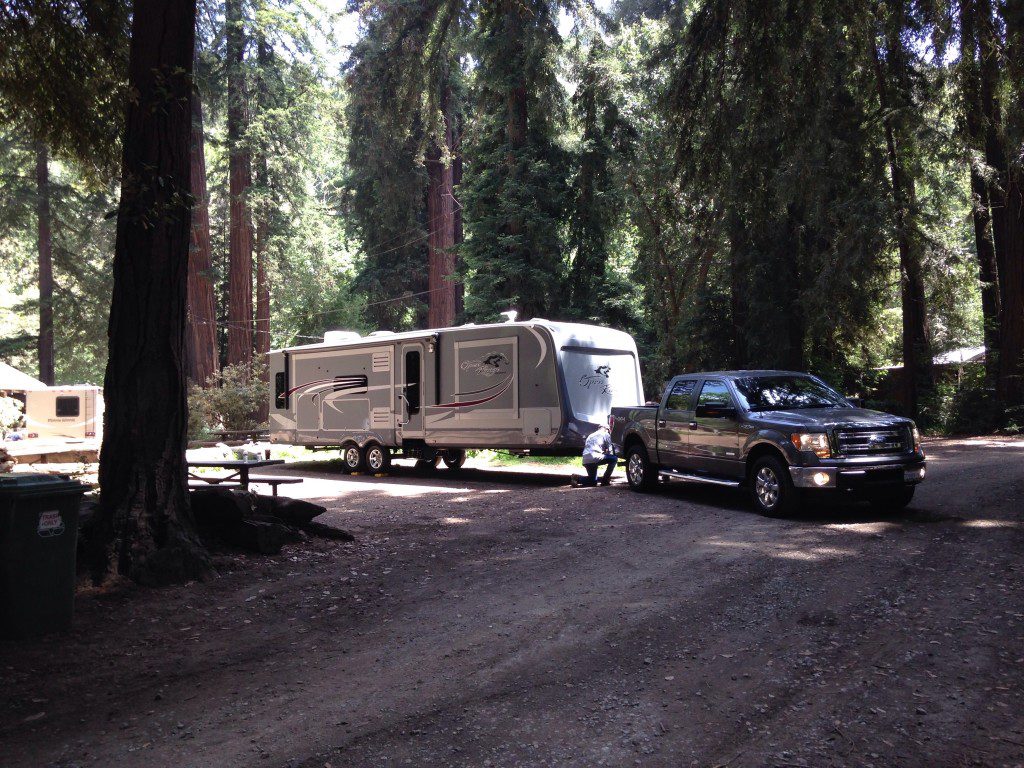 Truck towing RV in forest