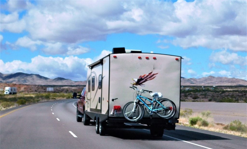 Truck towing travel trailer on highway