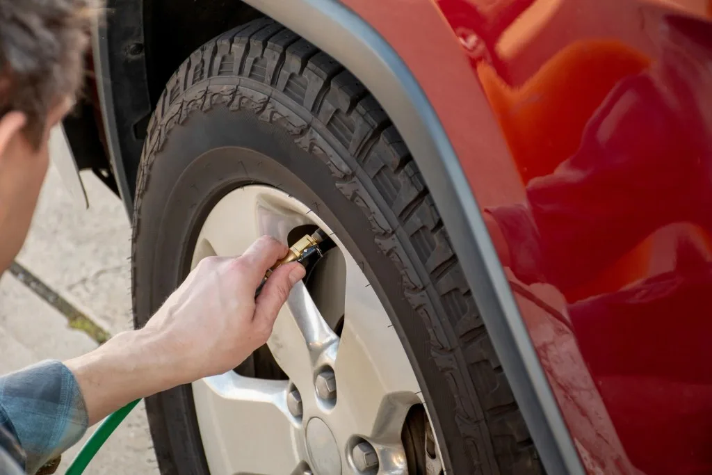 Man checking tire pressure