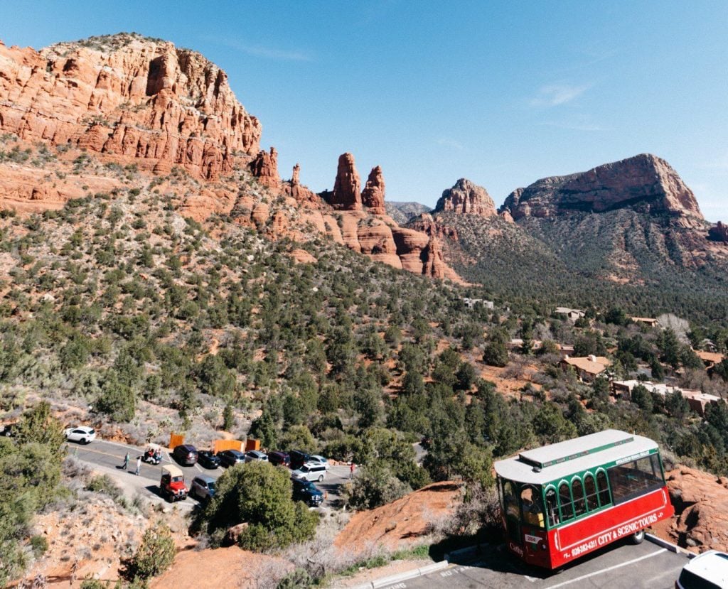 Trolley parked next to rock formation in Sedona.