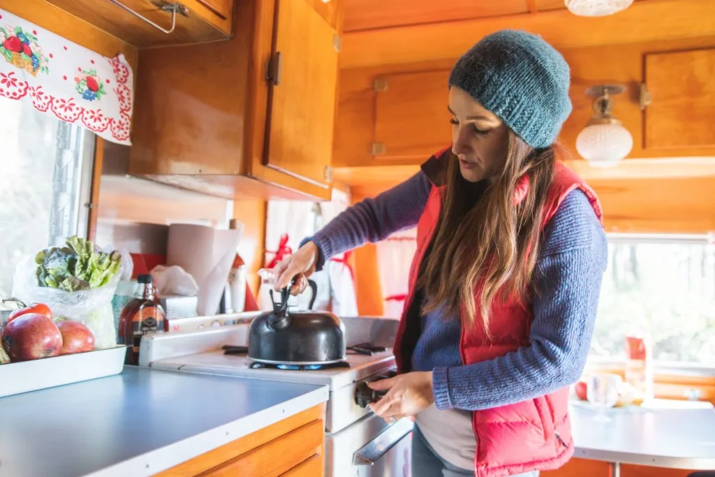 Woman in warm RV in fall 