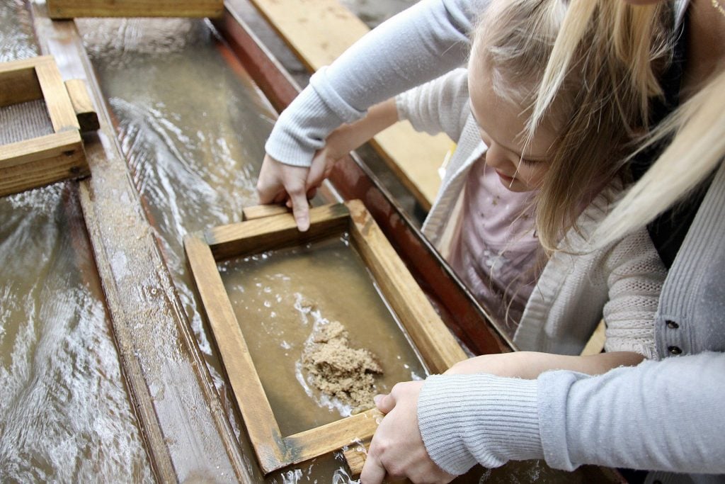 Mother and daughter panning for gold.