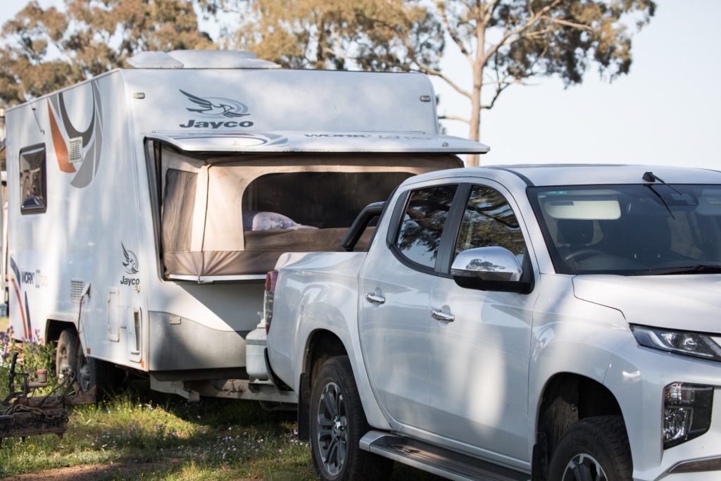 RV hitched to truck at campsite