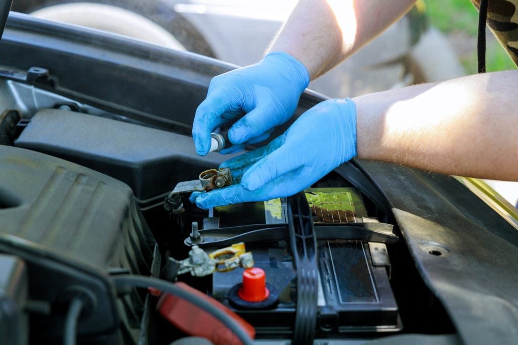Mechanic checking vehicle battery