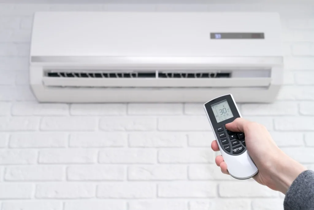 Woman turning on AC