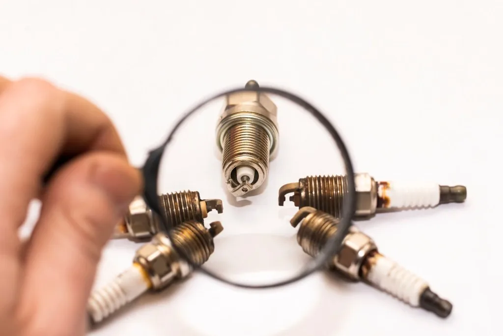 Spark plugs under a magnifying glass