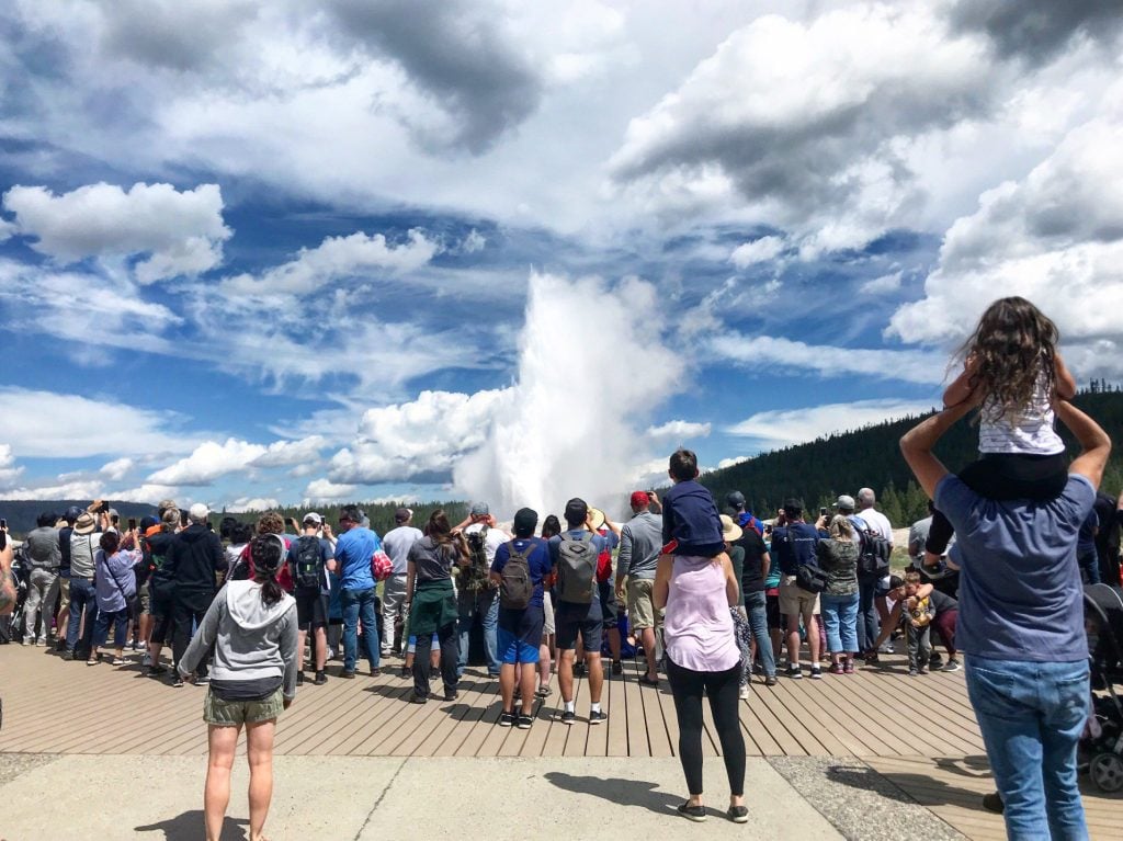 Crowds looking at Old Faithful.