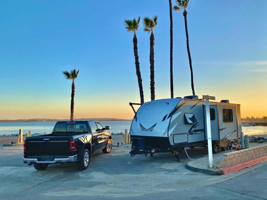 Truck parked next to RV after towing.